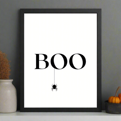 modern halloween art in black and white print on matte cardstock with word "boo" and hanging spider