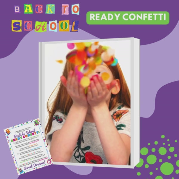 young girl with red hair blowing the back to school ready confetti and making a wish for a great first day of school
