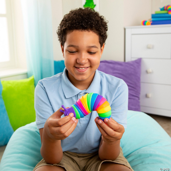 boy playing with rainbow fidget slug sensory toy