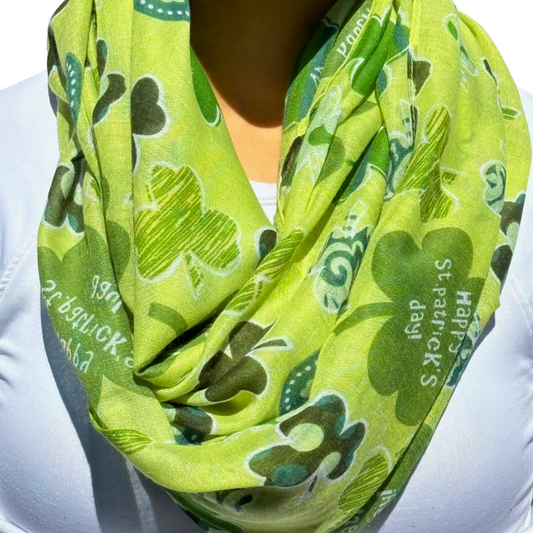 woman wearing a St. Patrick's Day green infinity scarf with different colors of green clovers in unique patterns