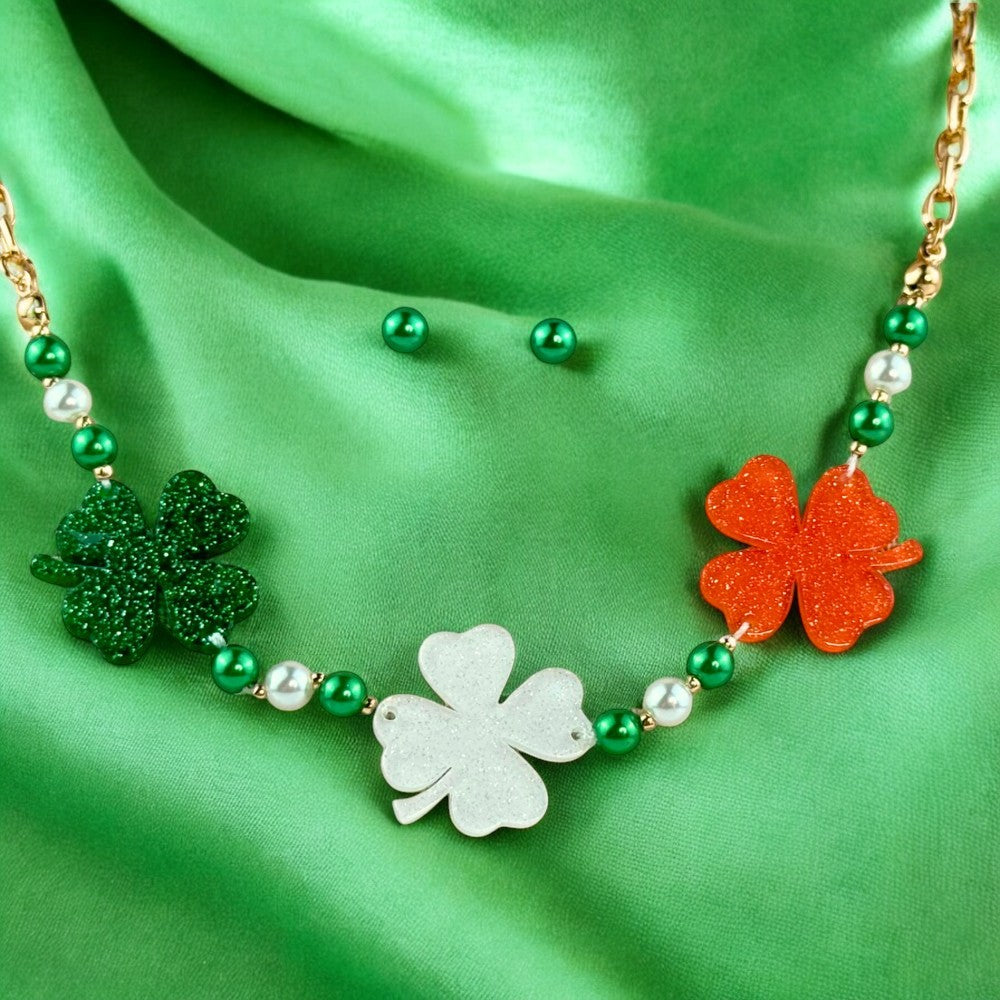 Green and white pearl necklace with Irish Flag Clovers and matching earrings set for St. Patrick's Day on green fabric