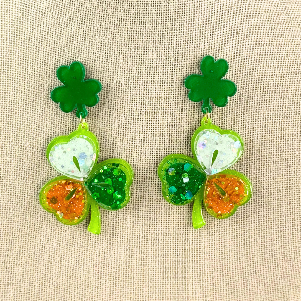 Irish flag colors Clover Acrylic earrings for St. Patrick's Day spirit. Festive, lightweight, lucky charm! on canvas background