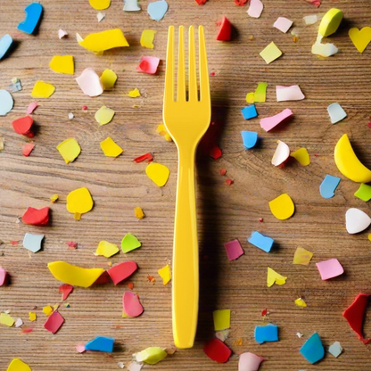 yellow heavy duty plastic fork with confetti on wood table